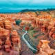Aerial view of red sandstone canyons with winding river below, Charyn Canyon, Kazakhstan